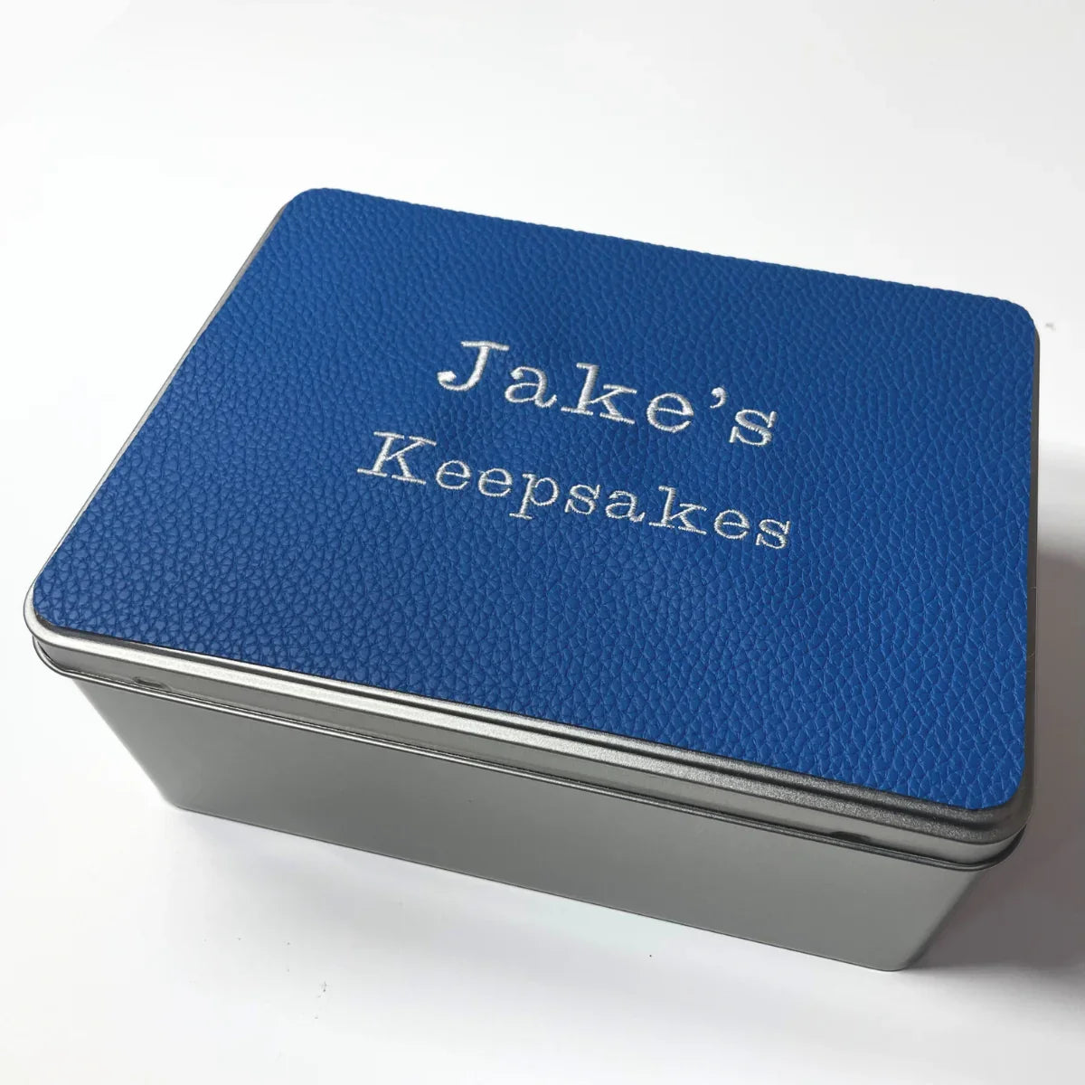 Blue keepsakes tin personalised with Jakes keepsakes embroidered on top