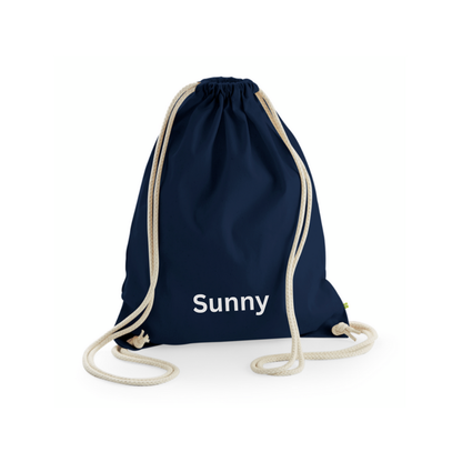A navy blue bag with cord drawstring handles, personalised for a child.